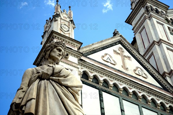 Firenze, Basilica of Santa Croce. Detail of the Dante Alighieri's statue closed to the gothic churc