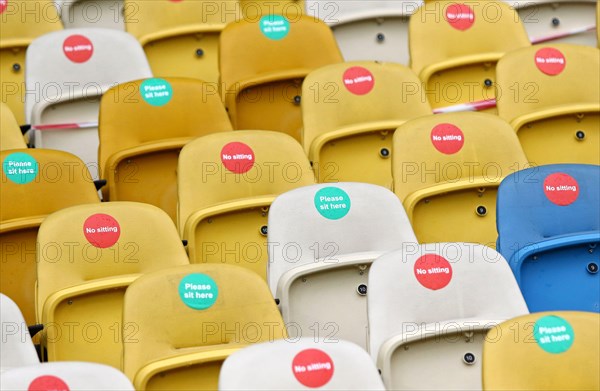 KYIV, UKRAINE - AUGUST 5, 2020: Seats with Covid-19 quarantine labels seen on the tribunes of NSC Olimpiyskyi stadium in Kyiv during the UEFA Europa League game Shakhtar Donetsk v VfL Wolfsburg