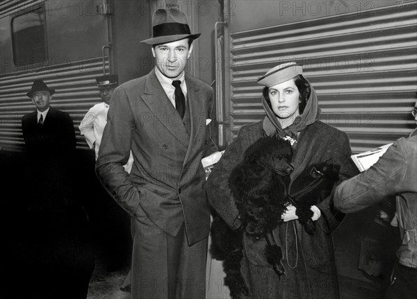 Gary Cooper arriving by train to Los Angeles, CA with his wife Veronica (Balfe) Cooper circa 1938 / File Reference # 34000-856THA