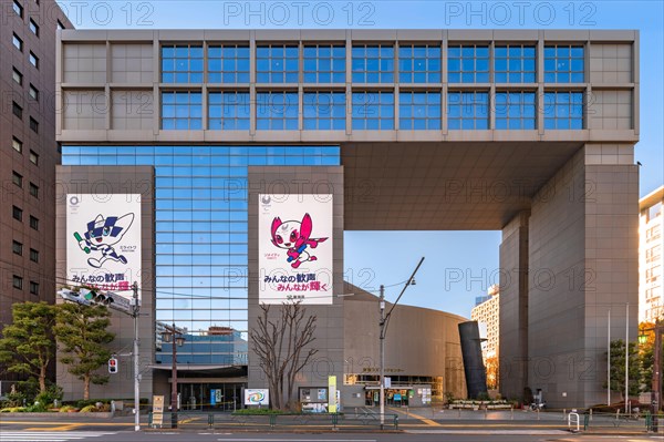 tokyo, japan - january 02 2021: Shinjuku Cosmics Center building decorated with posters of the 2020 Olympic and Paralympic Summer Games depicting the