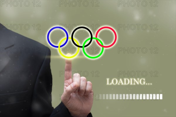TOKYO, JAPAN, MAY. 23. 2021: Businessman hand pointing Loading olympic Games Rings digital loading bar. Summer olympic game background concept, Tokyo