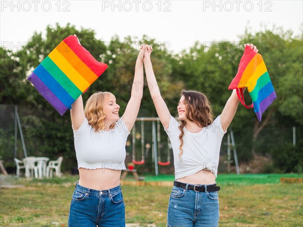 Young caucasian females holding the LGBT flags
