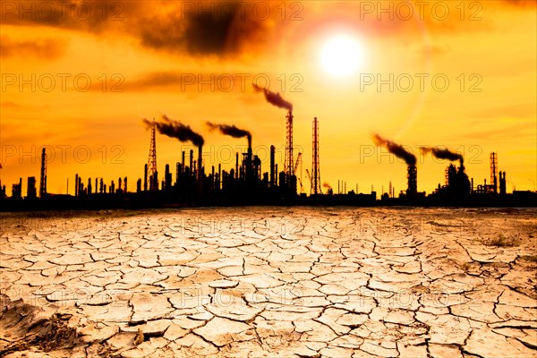 Refinery with smoke and global warming concept