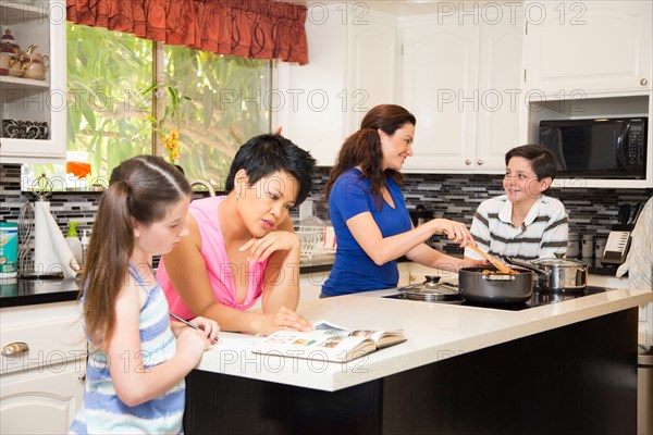Lesbian couple in kitchen with children