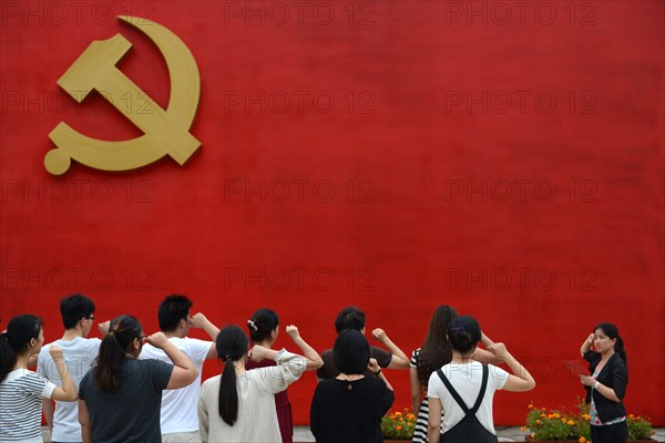 Chinese communists party members take an oath in front of the party flag sign at a  Party Memory Mesume as part of celebrations for the July 1 Chinese Communist Party's 94th anniversary in JiaXing, Zhejiang province, East China on 27th June 2015.