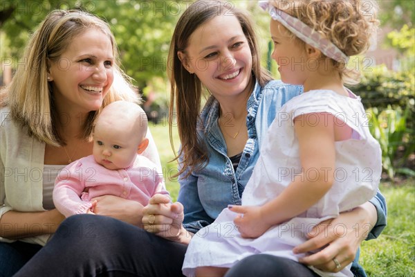 Caucasian mothers and daughters smiling in park