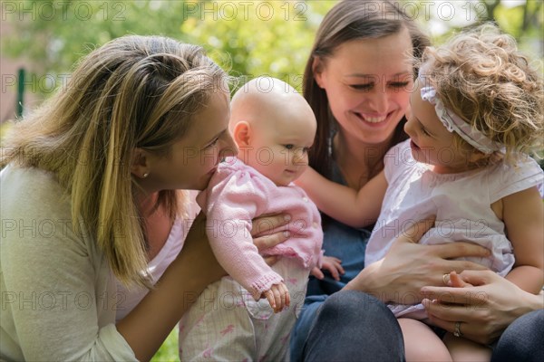 Caucasian mothers and daughters playing in park