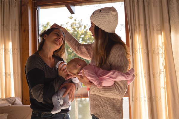 Lesbian couple holding their babies