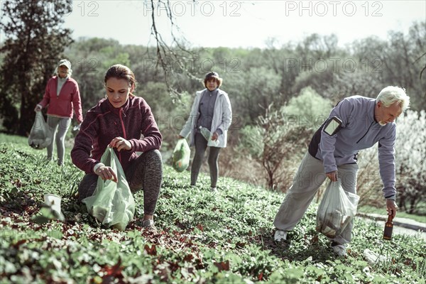 Volunteers cleaning up forest after inferior people