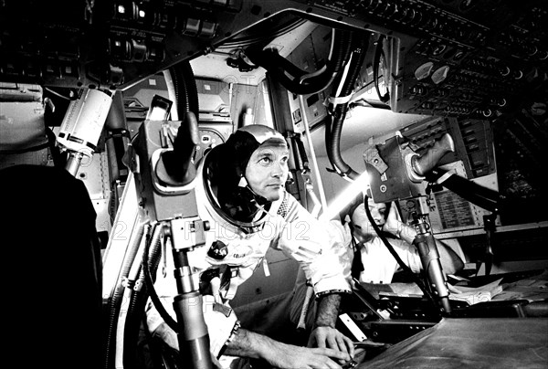 Photograph of the pilot Michael Collins at Apollo 11 Command Module, practicing docking hatch removal from CM simulator at NASA Johnson Space Center, Houston, Texas, June 28, 1969. Image courtesy National Aeronautics and Space Administration (NASA). ()