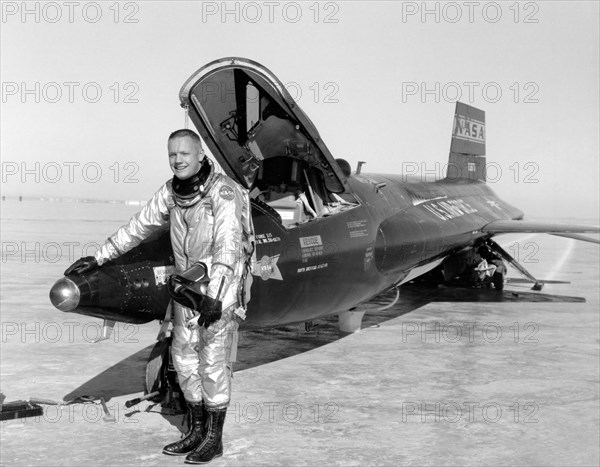 Dryden pilot Neil Armstrong poses next to the X-15 ship 1 rocket-powered aircraft after a research flight, November 30, 1959. Image courtesy National Aeronautics and Space Administration (NASA). ()