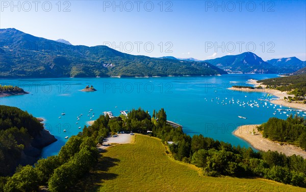 Picturesque view over artificial lake of Lac de Serre-Poncon in departments of Hautes-Alpes and Alpes-de-Haute-Provence, France