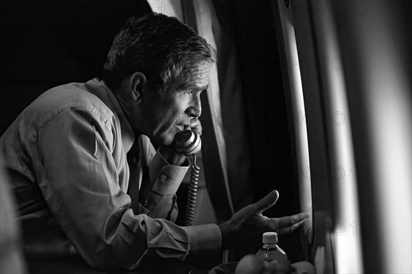 President George W. Bush talks on the phone with Vice President Dick Cheney from Air Force One after departing Offutt Air Force Base in Nebraska for Washington, D.C. on Tuesday, September 11, 2001.