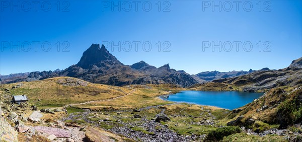 Pic du Midi d'Ossau mountain and Lac Gentau mountain lake in Ossau Valley, iconic symbol of the French Pyrenees, protected area of Pyrenees National P