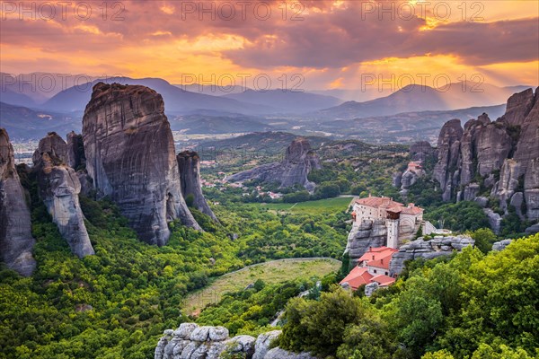 Meteora, Greece. Sandstone rock formations, the Rousanou and Nikolaos monasteries at sunset.