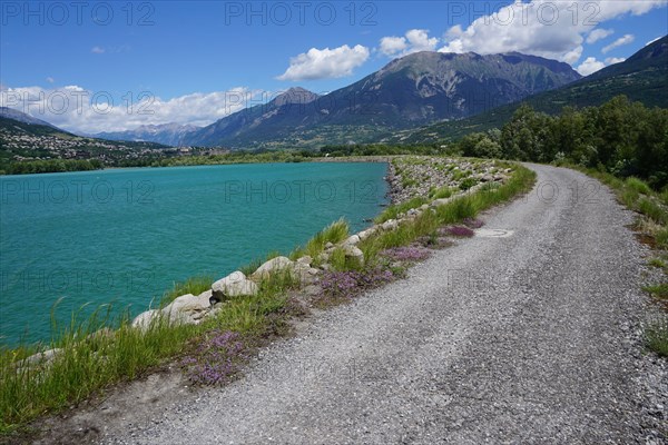 dirt road along the Serre Ponçon lake  in the mountains of southern Alps, France