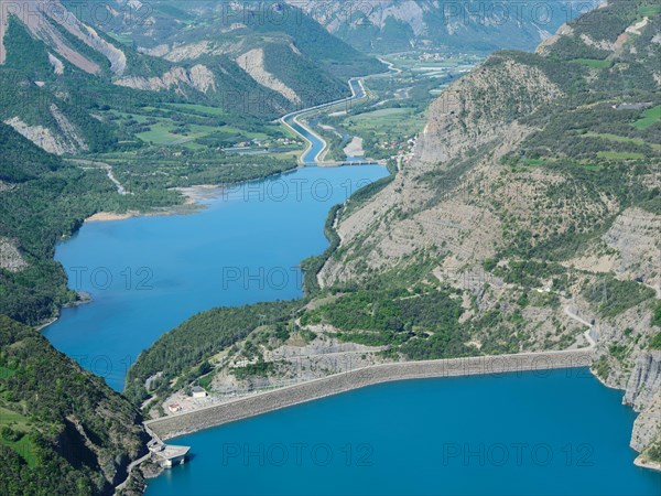 AERIAL VIEW - Dam of Lake Serre-Ponçon with the EDF canal and the Durance River in the distance. France.