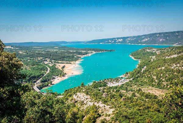 View of a turquoise lake and the surrounding forests