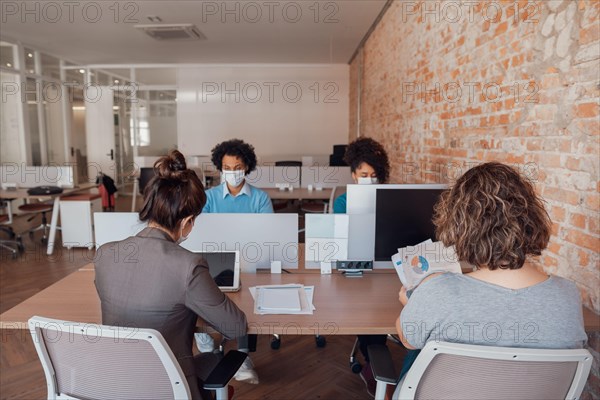 business colleagues working and typing on laptop and tablet in office workspace