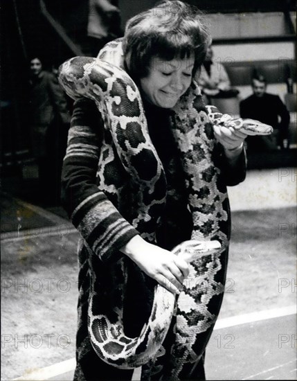 Apr. 04, 1970 - Regine as snake charmer: Regine, the famous French singer entertainer is back in Paris after a singing tour in America. She will participate in the annual charity show organised by the Union of artists. Photo shows Regine rehearsing her act as a snake charmer.