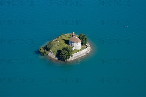 CHAPEL ON AN ISLAND SURROUNDED BY TURQUOISE WATERS (aerial view). Saint-Michel island, Chorges, Lake Serre-Ponçon, Hautes-Alpes, France.