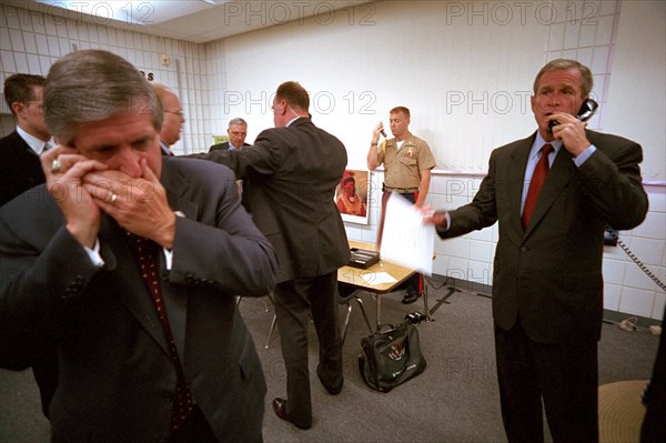 U.S. President George W. Bush and White House Chief of Staff Andy Card make phone calls after hearing news of the September 11 terrorist attacks during a visit to the Emma E. Booker Elementary School September 11, 2001 in Sarasota, Florida.