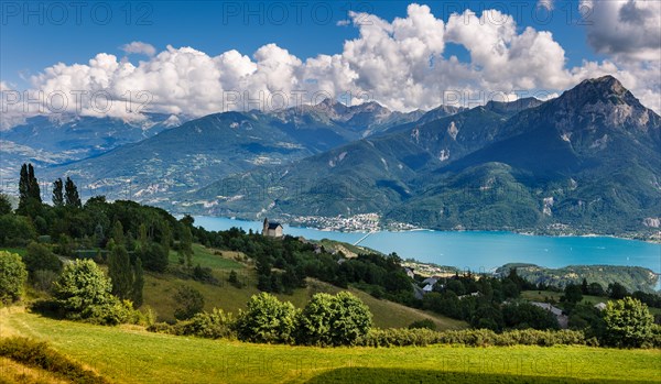 The village of Saint Apollinaire's church with Summer view on Savines-le-Lac, Serre Poncon Lake and Grand Morgon, Alps, France