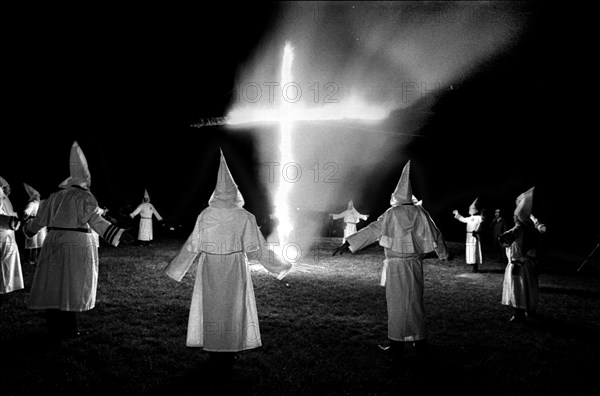 Members of the KKK circle a cross lighting in Rumford Me during rally in the small town Maine town. The Klan had been active in Maine in the 1920's and 30's , This group of Klansmen openly invited the press to observe ,photograph and report on this event photo by bill belknap