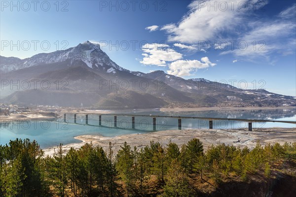 Pont de Savines with Serre-Poncon lake and the Grand Morgon on an early winter morning. Savines-le-Lac, Hautes-Alpes, Southern French Alps. France