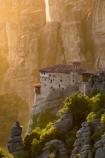 Beautiful scenic sunset view of the Rousanou (St. Barbara) Monastery on a monolithic pillar in Meteora, Greece