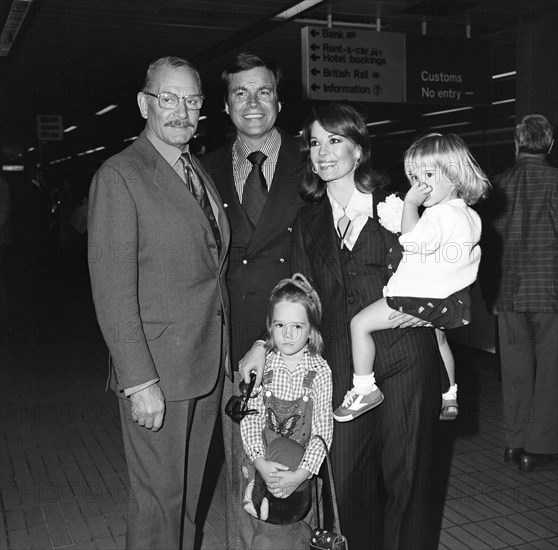 Film actor Robert Wagner and his wife Natalie Wood arrived at Heathrow Airport from Los Angeles with their children Courtney (2) and Natasha (5). Courtney was carrying a doll called 'Curious George.' They were met by Lord Olivier and are here to make a Granada TV production with him of 'Cat on a Hot Tin Roof .' 19th May 1976.