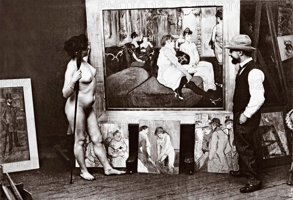 Toulouse-Lautrec and naked model in his studio standing in front of his 1893 painting Au Salon de la rue des Moulins. Henri Marie Raymond Toulouse-Lautrec, aka Henri de Toulouse-Lautrec, 1864-1901. French Post-Impressionist artist, printmaker, draughtsman, caricaturist, and illustrator. Photograph by Maurice Guibert, 1856-1913.