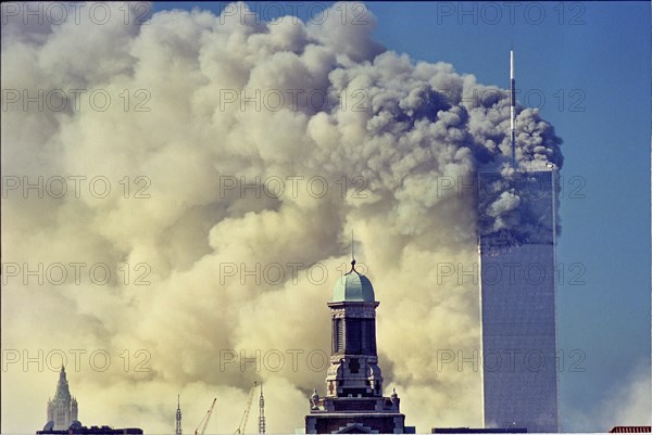 World Trade Center Attack photos taken from 14 street on a rooftop as the towers burn and one is falling.