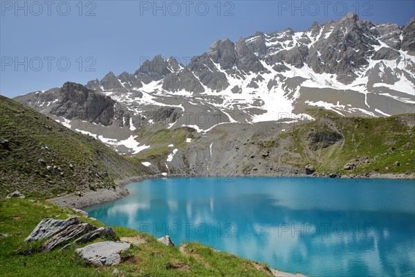 Sainte Anne lake located above Ceillac village after two hours hike, with reflections of mountain range, Queyras Natural Park, Southern Alps, France
