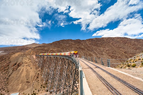 Train to the clouds (tren a las nubes) crossing La Polvorilla bridge in the Altiplano 4.200 meters/13800 feet high, Salta Province, Argentina