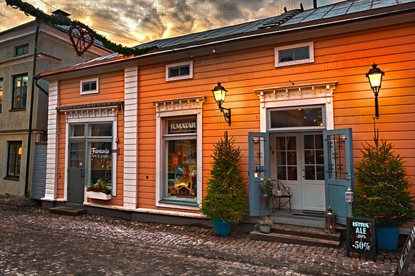 Porvoo, Finland - December 25, 2018: old town street gift shop with christmas decorations and nice street lanterns.