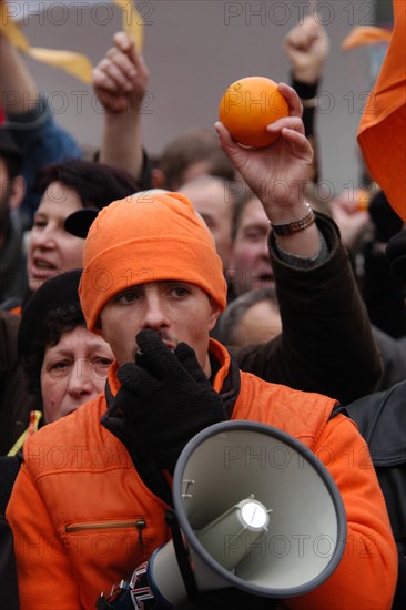 Orange revolution in Ukraine. Young man dressed orange speaks using a loudspeaker during the demonstration of Ukrainian migrants in the Czech Republic to support Ukrainian oppositional presidential candidate Viktor Yushchenko in Wenceslas Square in Prague, Czech Republic, on November 28, 2004.