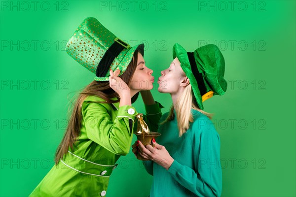 Irish traditions. Young women celebrating St Patrick's Day in pub. Isolated.