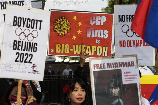 London, UK. 23rd June, 2021. Free Tibet campaigners and members of the Hong Kong, Tibetan and Uyghur communities hold a rally opposite Downing Street as part of a global day of action in protest against the Beijing 2022 Winter Games. Speakers condemned the International Olympic Committee (IOC) for its insistence that the Beijing 2022 Winter Games should go ahead in spite of the Chinese government's human rights violations against the Uyghur people and in Tibet, Hong Kong and Southern Mongolia and called on the UK government and British Olympic Association to boycott the games. Credit: Mark Ker