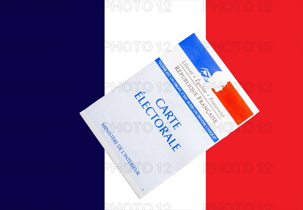 french voting card or carte electorale on top of French flag .