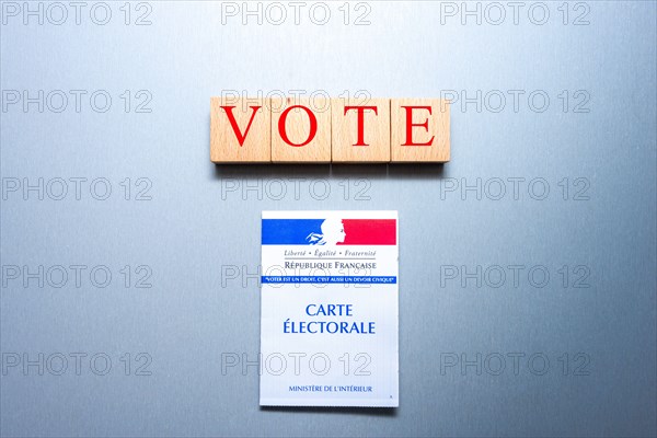 French voting card or carte electorale with wooden blocks and the word vote on them
