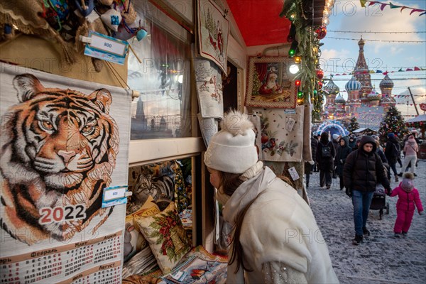 Moscow, Russia. 25th of December, 2021 People buy Christmas souvenirs at the Res Square during annual festival "Journey to Christmas" in the center of Moscow, Russia. The 2022 year will be the Tiger in the Chinese or Eastern calendar