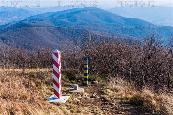 Border markers on a Polish-Ukraine boundary. The Polish eastern border, is also the border of the European Union and NATO. In the background mountains