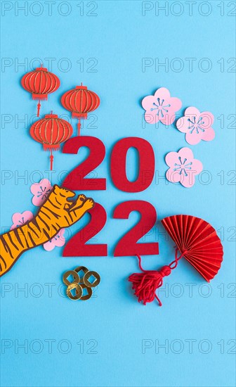 Chinese New Year, year of the tiger. Paper decoration with traditional motifs and tiger on blue background. Copy space.