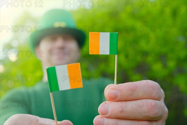 St.Patrick 's Day. Ireland flag and clover flowers .Saint Patrick background. Irish traditional spring holiday.