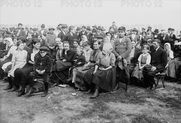 Vintage photo circa 1907 of immigrants waiting to be processed at Ellis Island in New York.