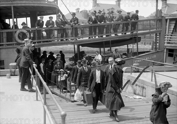 Vintage photo circa 1907 of immigrants disembarking from a ship at Ellis Island in New York.