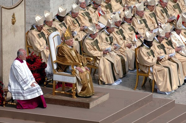(dpa) - Pope Benedict XVI (2nd from L, front), dressed in the papal robe with tiara, sits on a chair next to the cardinals during the church service on St Peter's Square at the Vatican in Rome, Italy, 24 April 2005. Pope Benedict XVI was inaugurated as the new head of the Roman-Catholic church, today on Sunday, 24 April 2005.