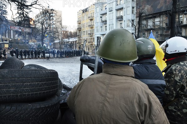 Kiev, Ukraine. 02nd Feb, 2014. Protesters look towards a line of police from behind their makeshift barricade. The so-called EuroMaidan demonstrations began after plans for closer integration with Europe were scrapped in November 2013. Credit:  Oleksandr Rupeta/Alamy Live News