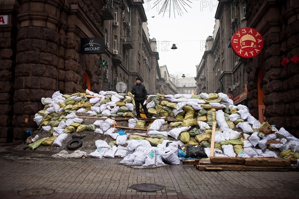 Kiev, Ukraine. 12th Feb, 2014. An anti protester stands on a barricade in maidan square on February 12, 2014. Russia will release the next installment of its $15-billion loan to Ukraine at the end of the month, a newspaper close to President Viktor Yanukovych said on February 10, following talks between Ukraine's leader and his Russian counterpart. Photo by Emeric Fohlen/NurPhoto Credit:  Emeric Fohlen/NurPhoto/ZUMAPRESS.com/Alamy Live News